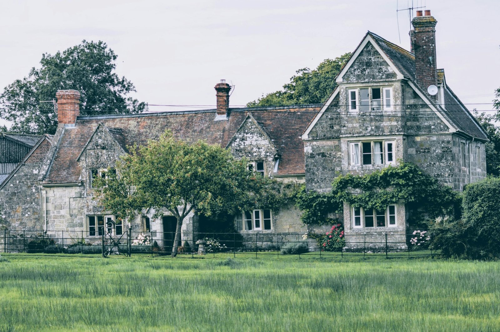 Picturesque old stone house in rural countryside with lush greenery, perfect for serene nature retreats.